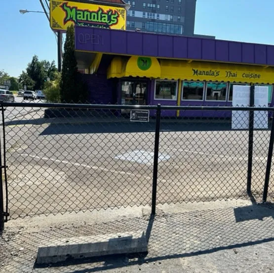 Black vinyl-coated chain link fence at commercial storefront in Eugene, Oregon